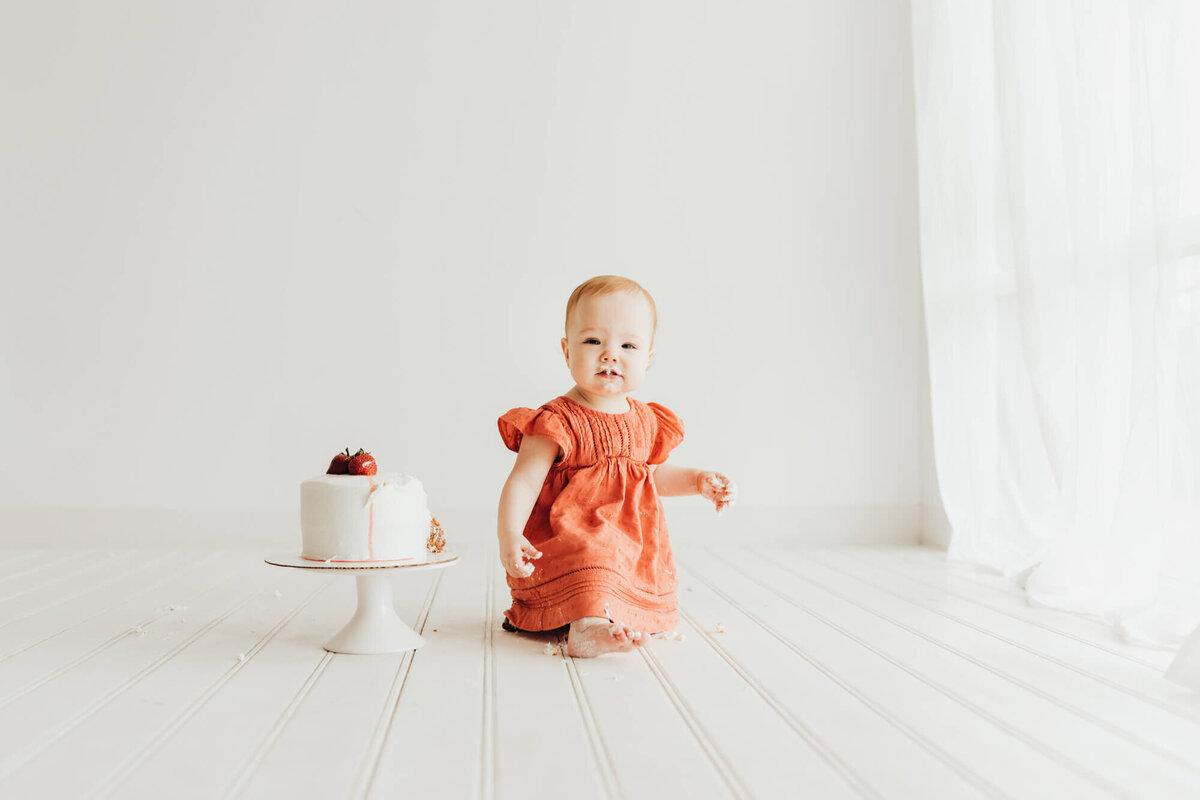 birthday cake and little girl in studio.