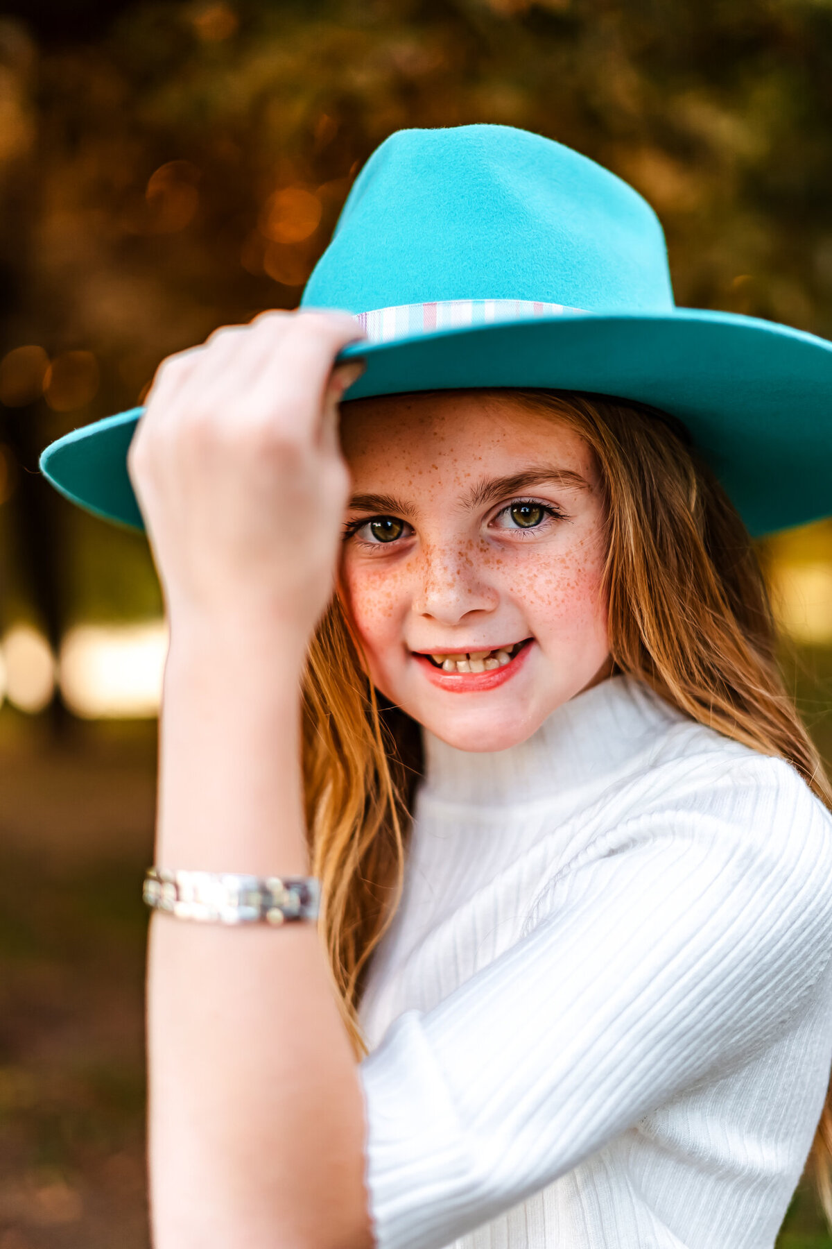 Girl in a blue hat smiling