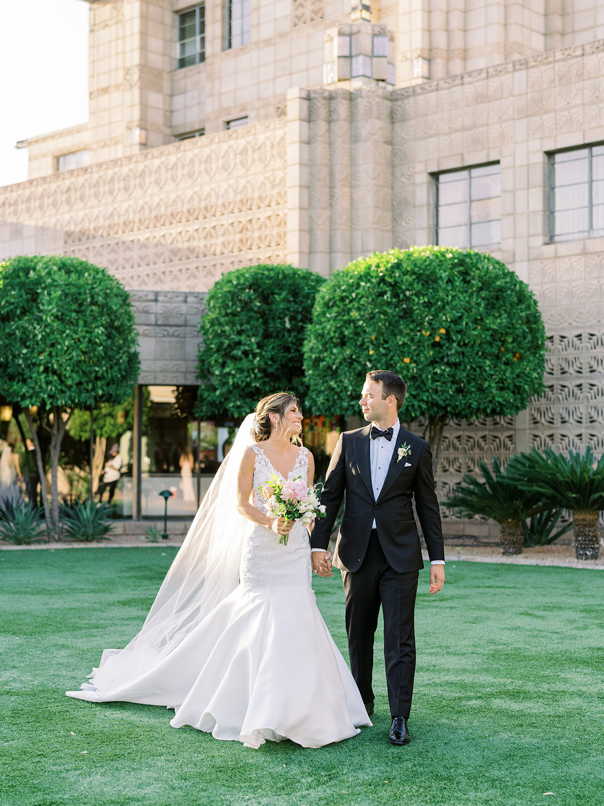 bride and groom walking at luxury destination wedding venue