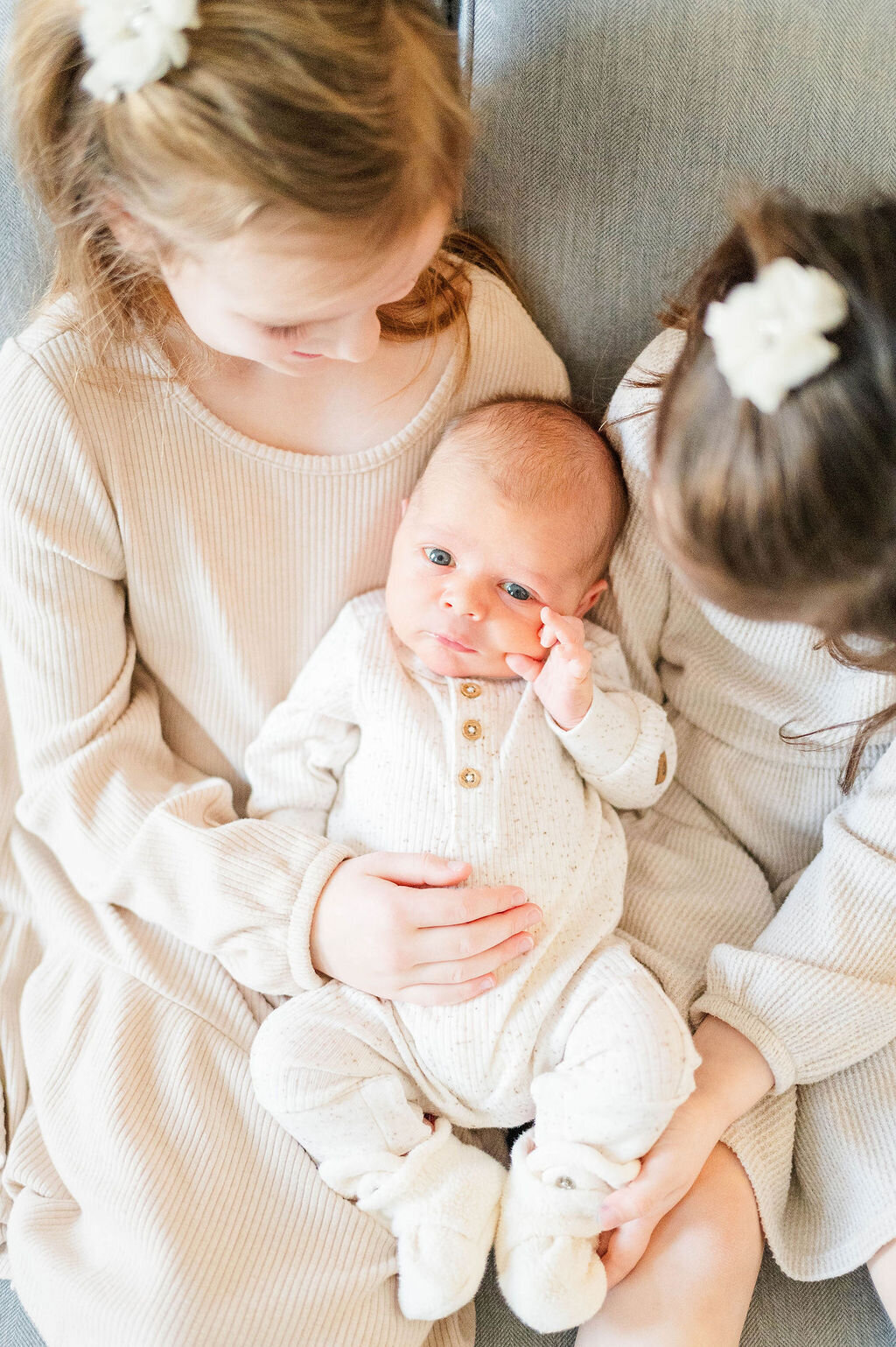Newborn baby boy with his big sisters taken in Sutton, MA taken by the best newborn photographer in Central, MA