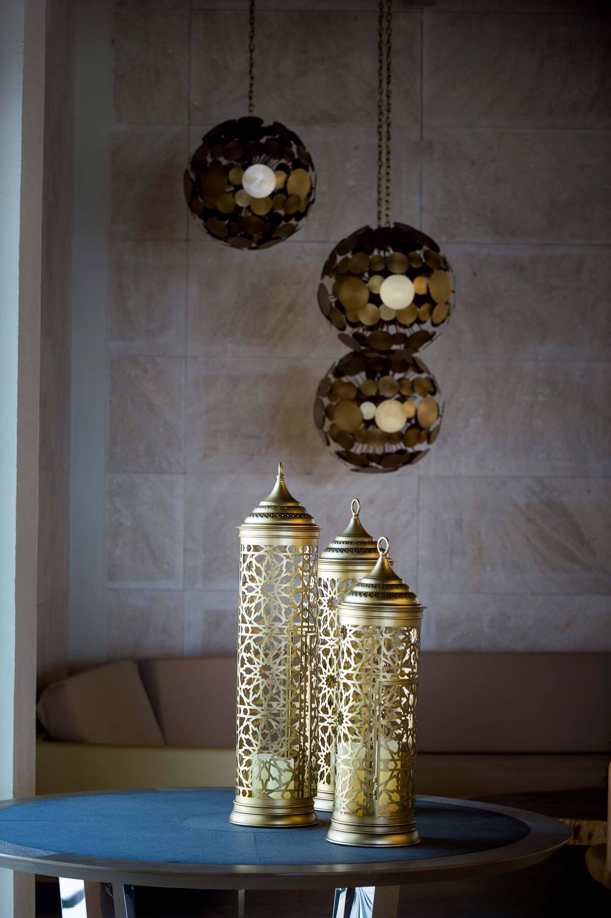 Ornate decorations made of brass sit on coffee table and hang from ceiling at the Mauna Lani Hotel