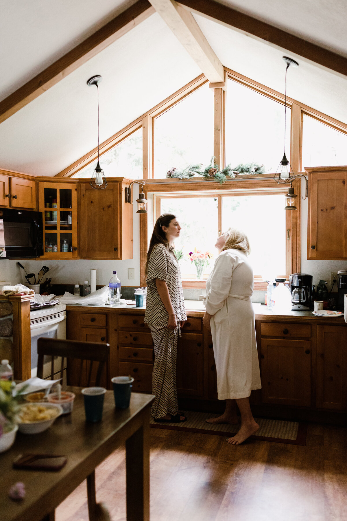 Women in the kitchen of cabin at Dallenbach Ranch Colorado Wedding