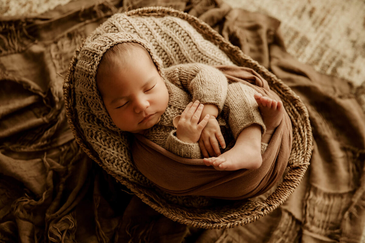 Baby boy sleeping in a basket for a newborn portrait in OKC.