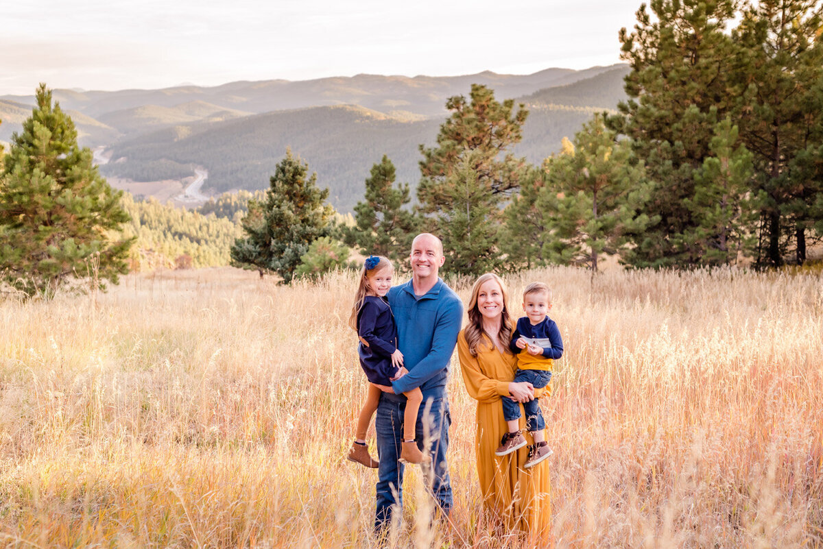 colorado-fall-family-standing-in-field-in-mountains