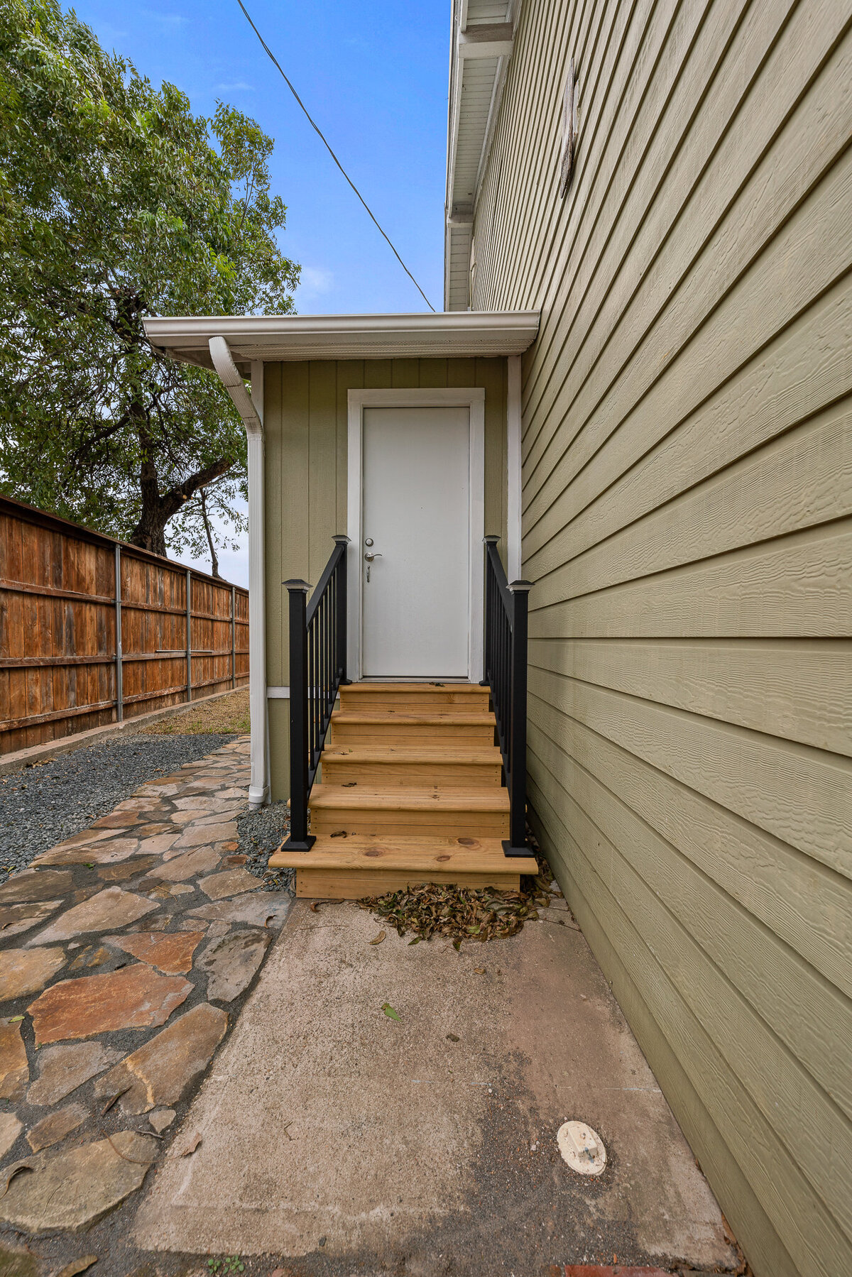 Side entrance of this five-bedroom, 4-bathroom pet-friendly vacation rental house for 12 guests with free wifi, free parking, hot tub, mother-in-law suite, King beds and updated kitchen in downtown Waco, TX.