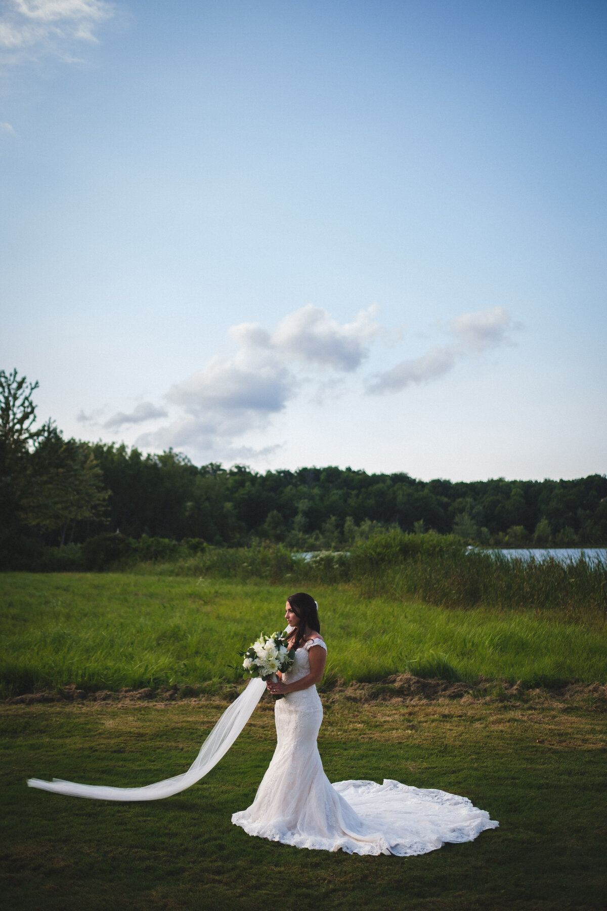 Bride standing in field