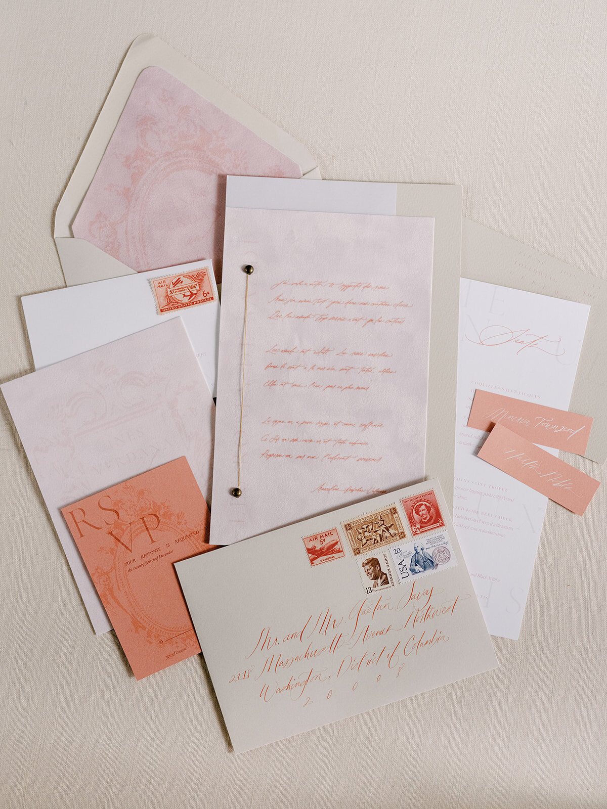 Paper suite flatlay with blush touches and natural tones embellished with calligraphy.
