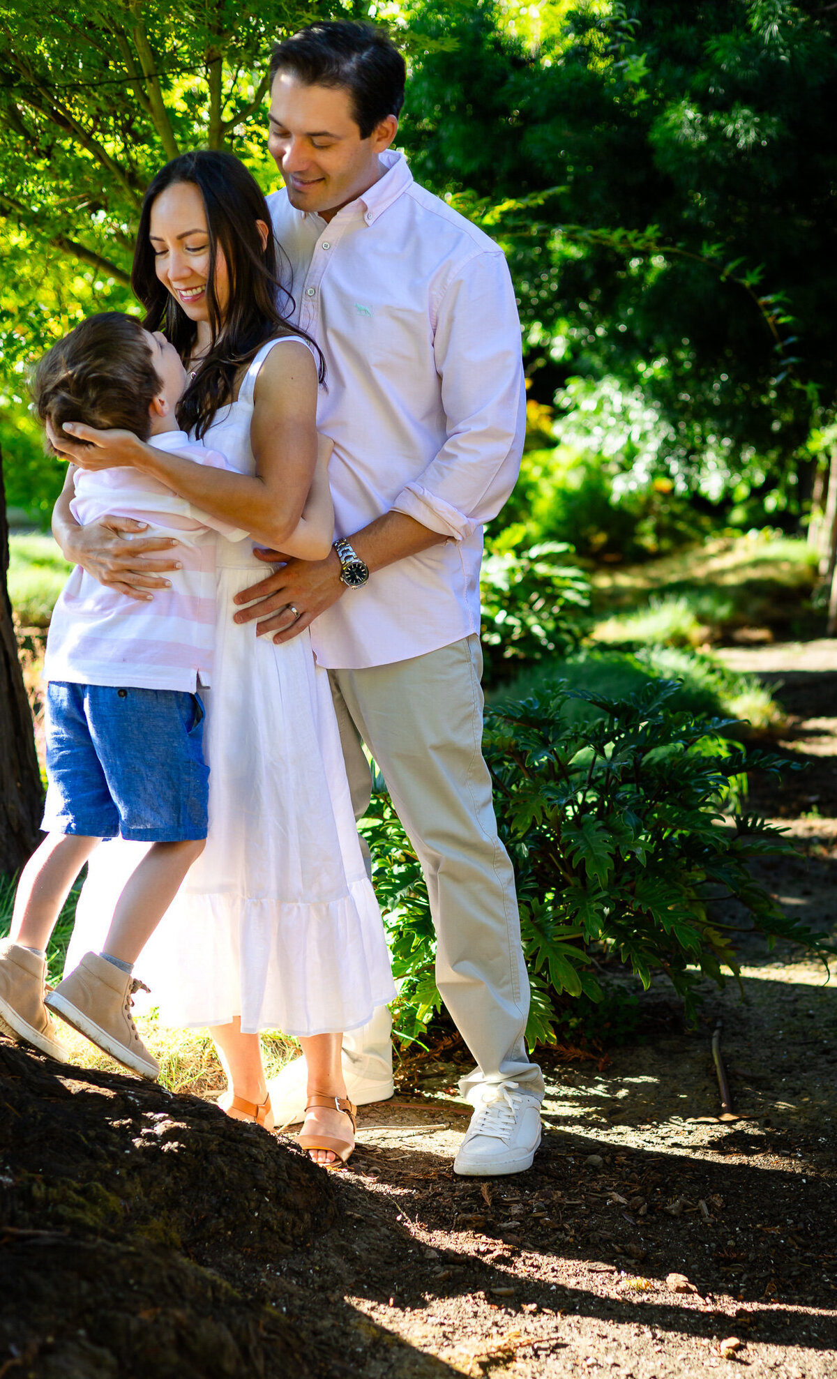 Young boy hugging father as mother smiles nearby, Bay Area Family Portfolio – Ellobelle Photography