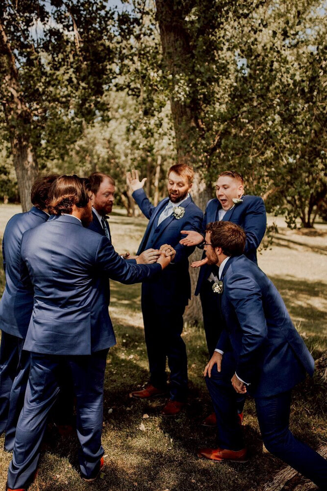 storyteller-collective-photo-co-groomsmen-celebrating-in-park-in-nebraska