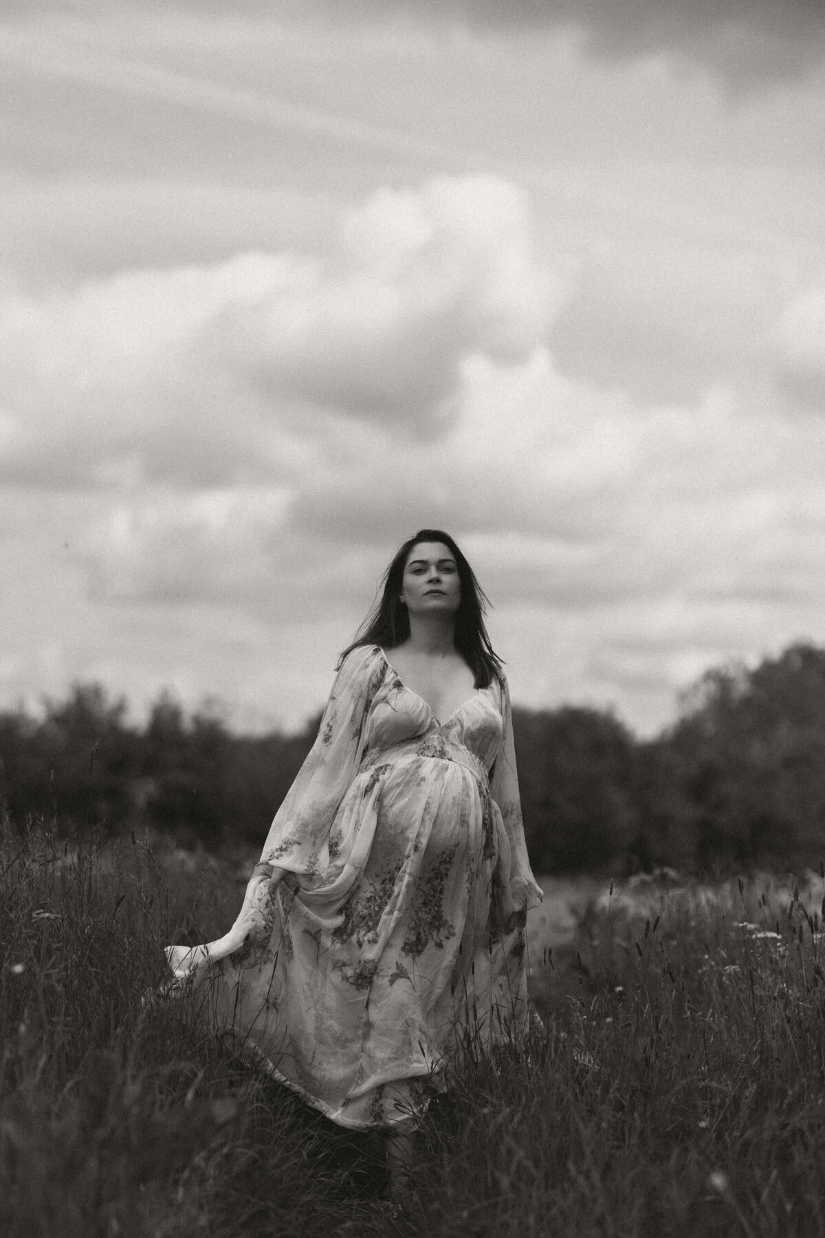 pregnant woman in a flowy dress in a field