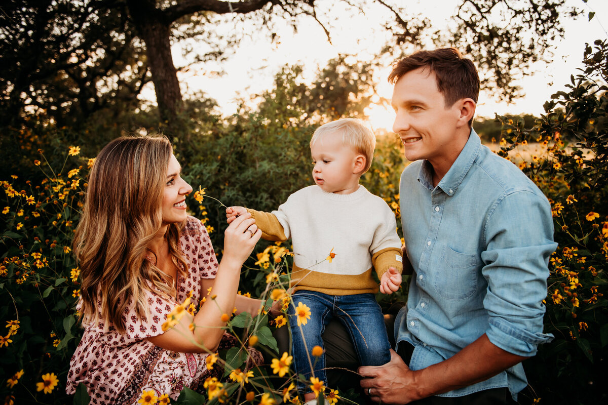Family Photography, Mom, Dad, and little boy playing in the wildflowers.