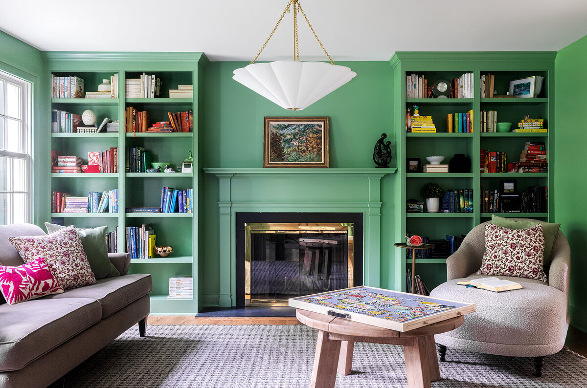 living room with green built-in shelves and fireplace