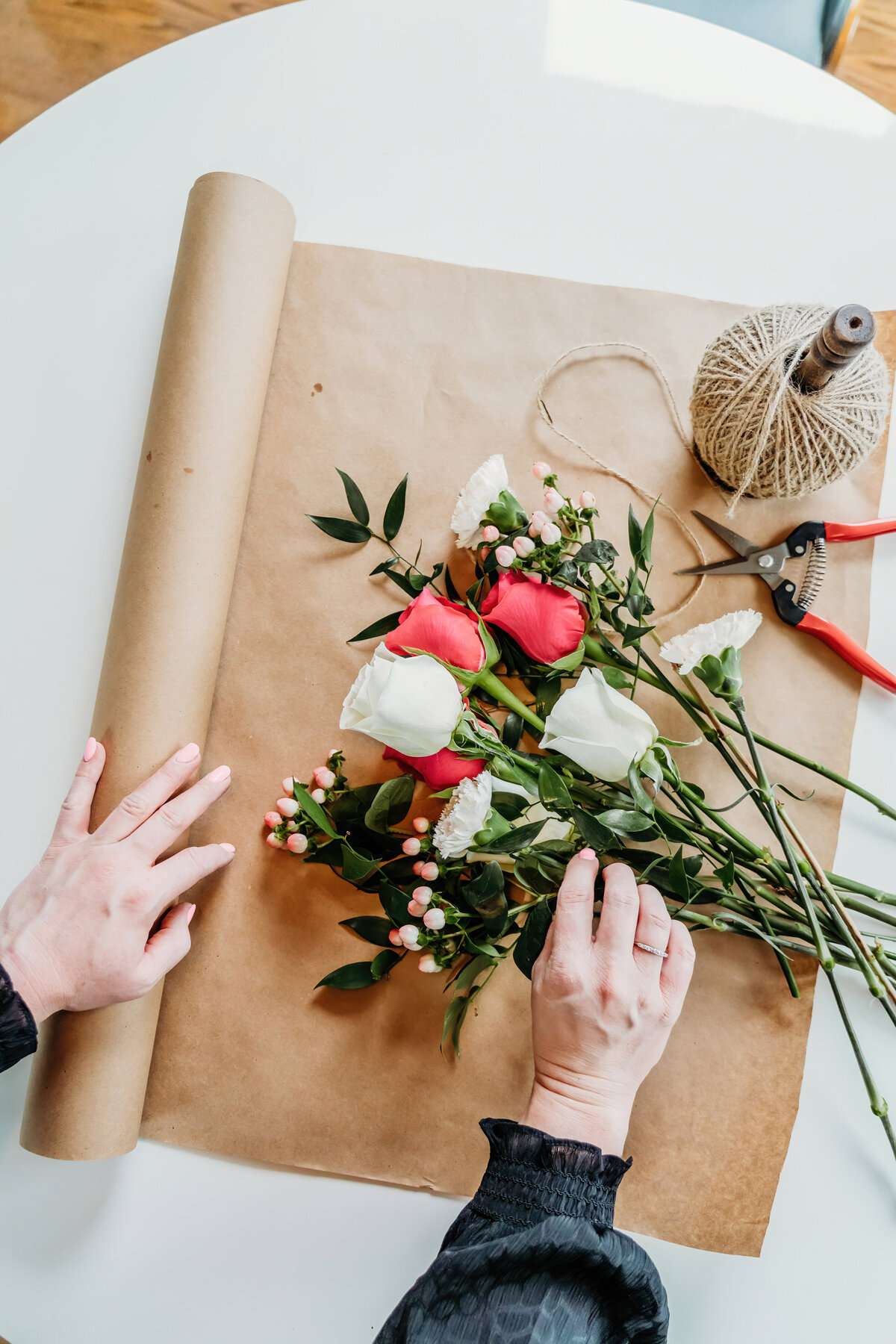 a branding photoshoot for a local washington florist, photo is of her hands putting together a bouquet