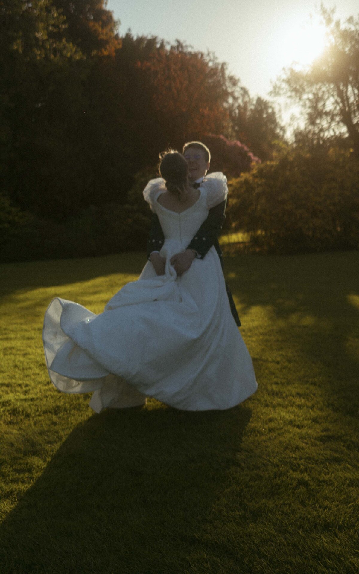 Romantic sunset photoshoot of a couple, capturing their love against the breathtaking golden hues of the setting sun