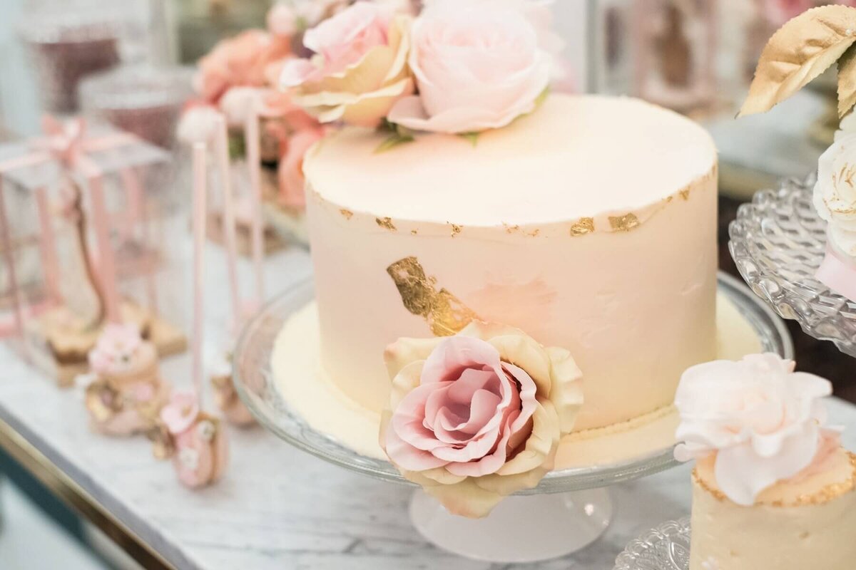 Beautiful cake with gold leaf details and roses