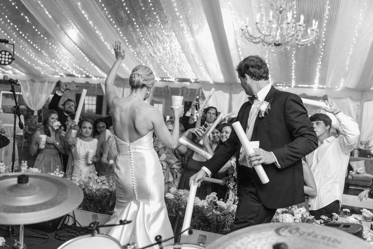 bride and groom dance on-stage at their wedding reception