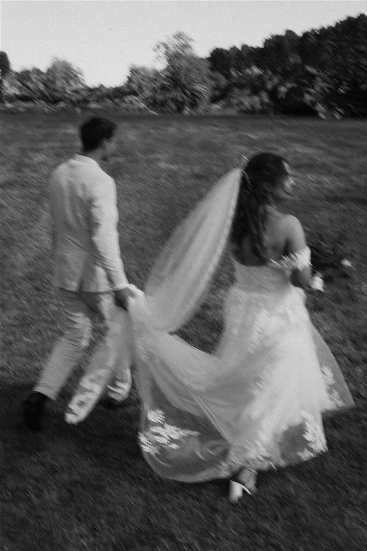 new zealand couple walking blurry photo wedding day