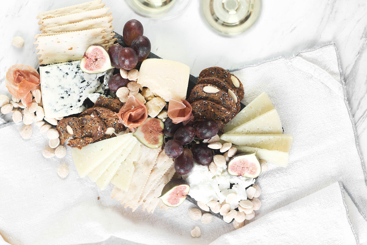 Charcuterie board with figs, cheese, grapes,etc