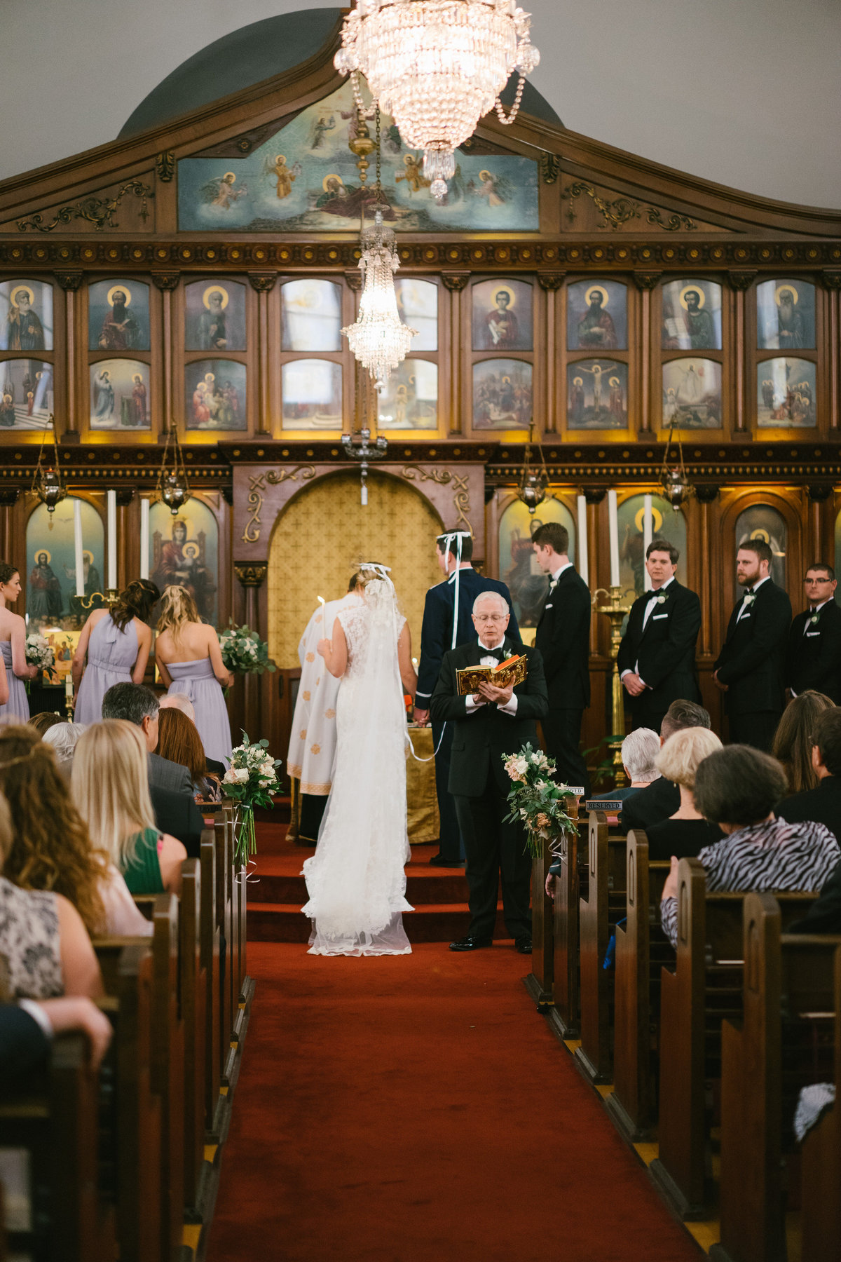 bride and groom standing at altar in greek orthodox wedding at St. Sophia Greek Orthodox Church in San Antonio
