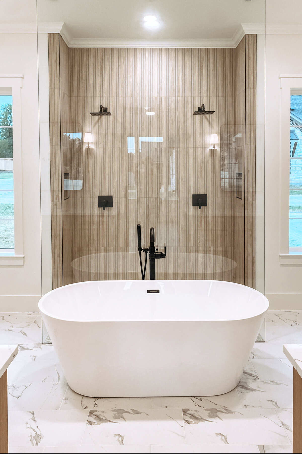 free standing top in front of frameless glass shower with two showerheads