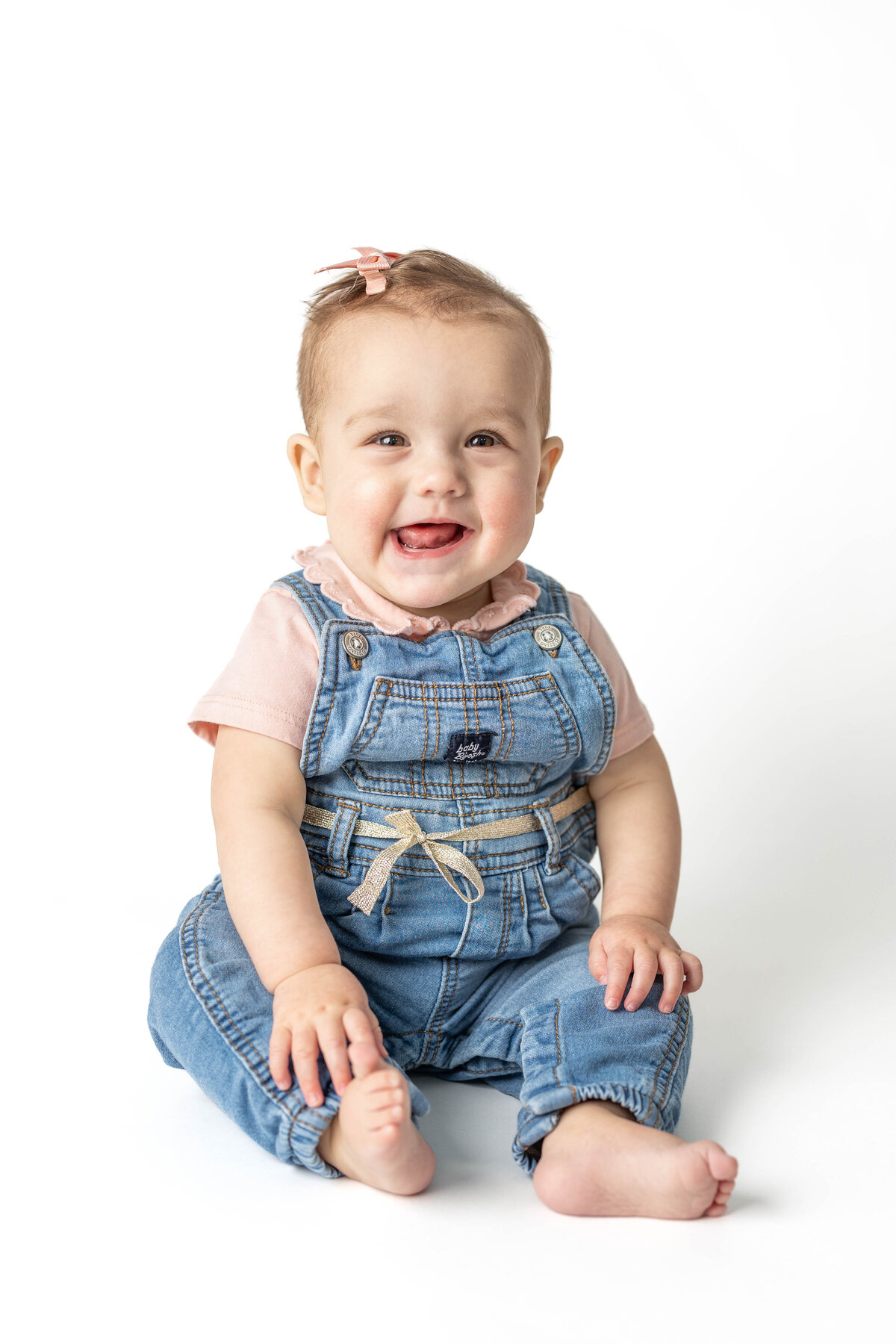 8 month old girl in overalls for school picture