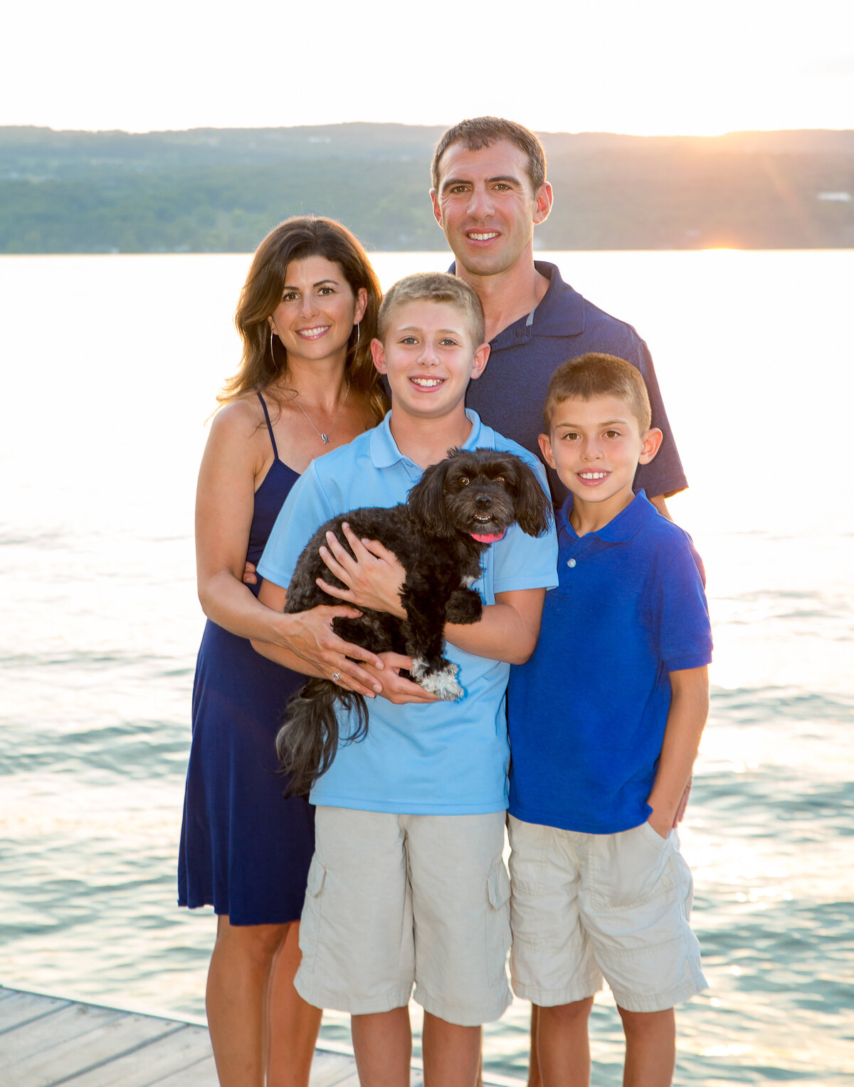 family picture with two boys and a dog on Canandaigua Lake