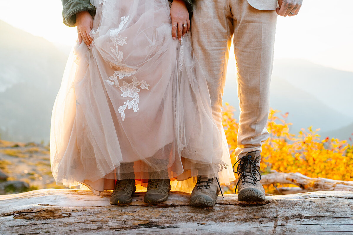 Bride & grooms showing off hiking boots during their adventure elopement near Mount Baker!
