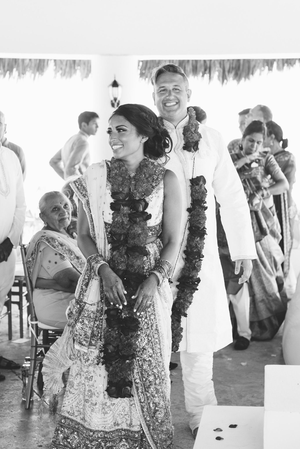 Joy from a bride and groom at the close of their Indian wedding ceremony.  Photography by Rebecca Cerasani.