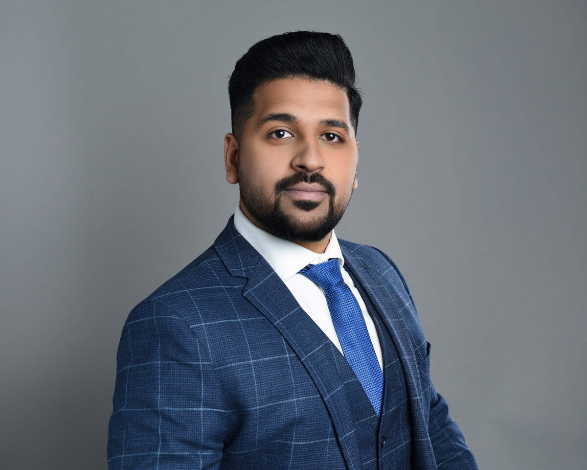 lose-up business portrait of a confident man in a blue suit, ideal for LinkedIn, taken by a Toronto headshot photographer.
