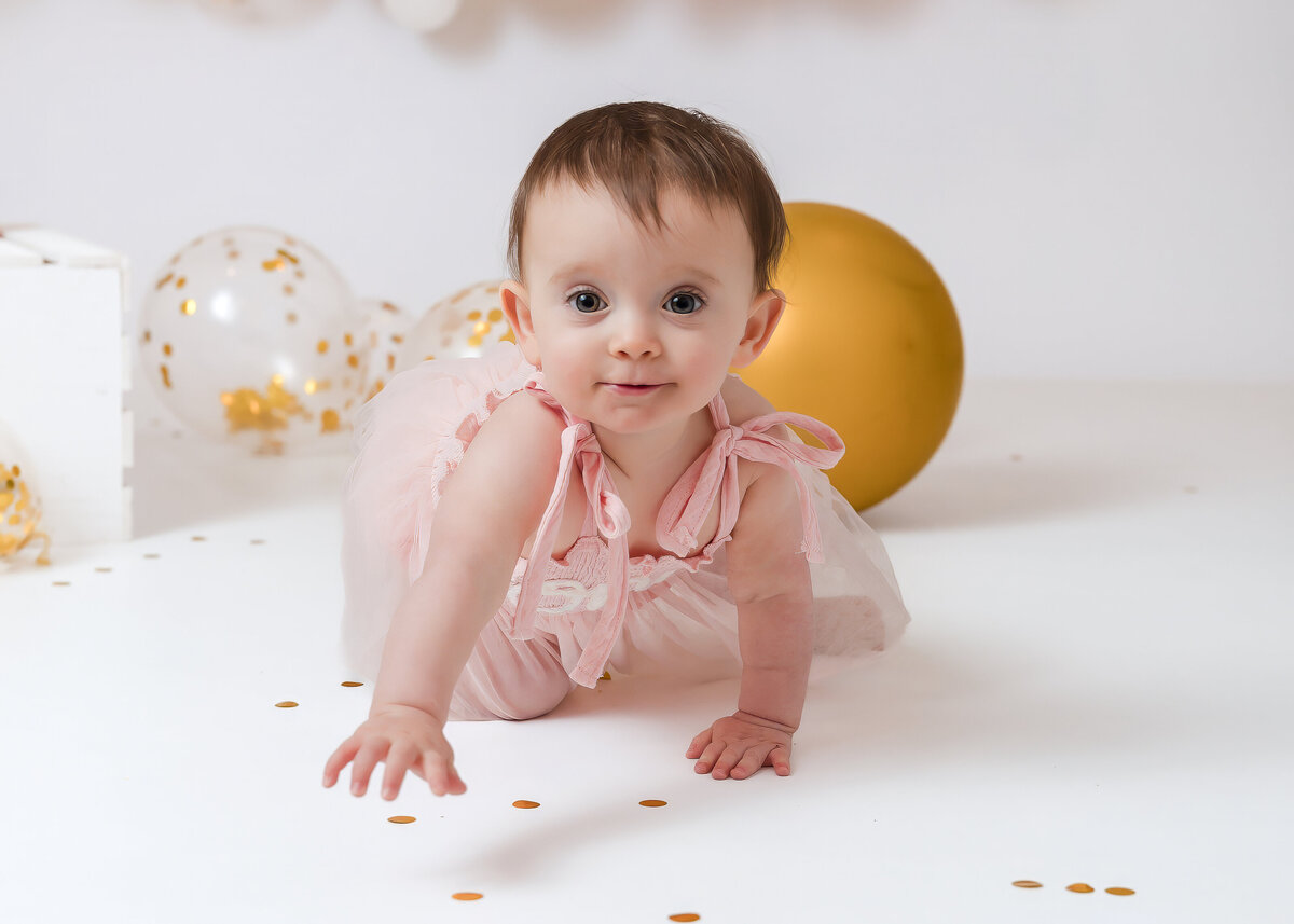 Light and airy photo of 1 year old baby crawling at Allison Reilly's Union County, NJ photo studio.