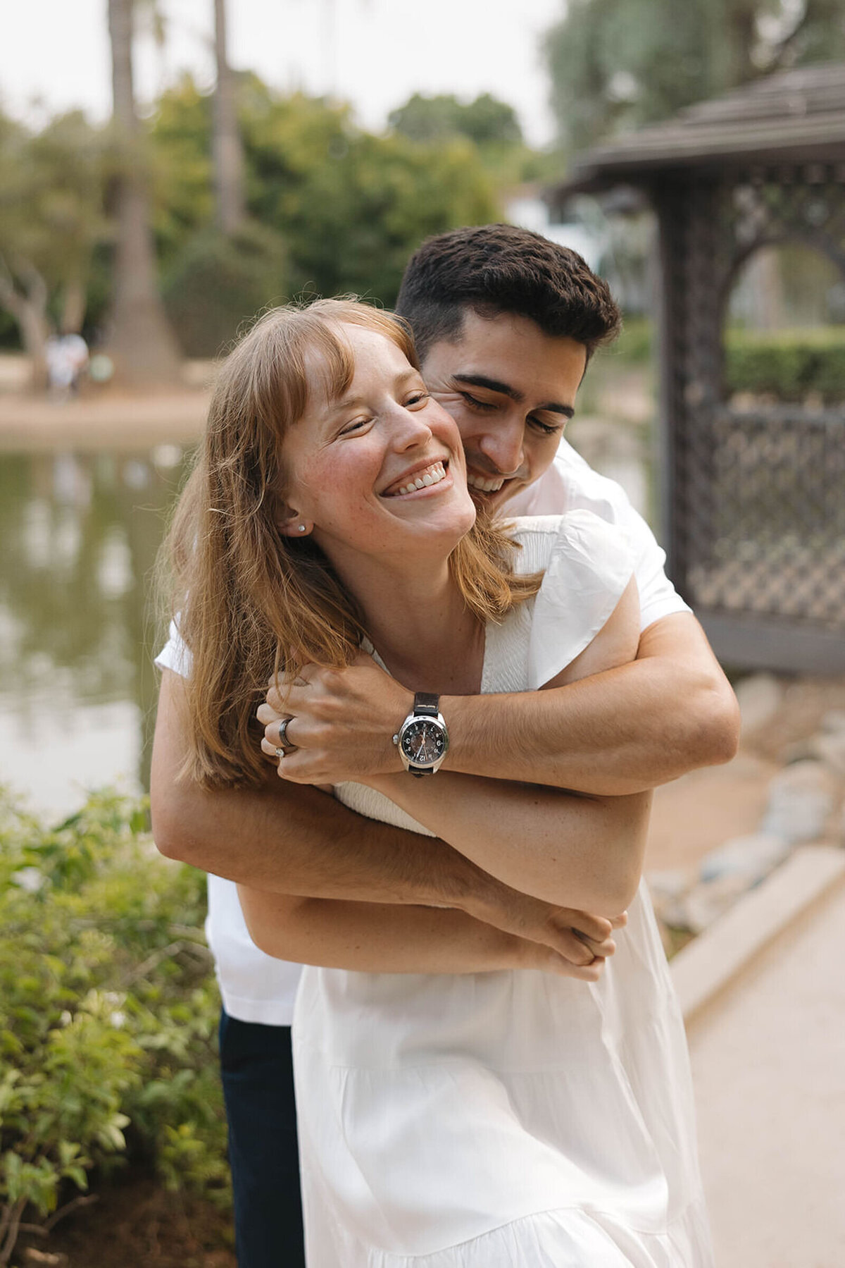 Engaged couple hugging and laughing