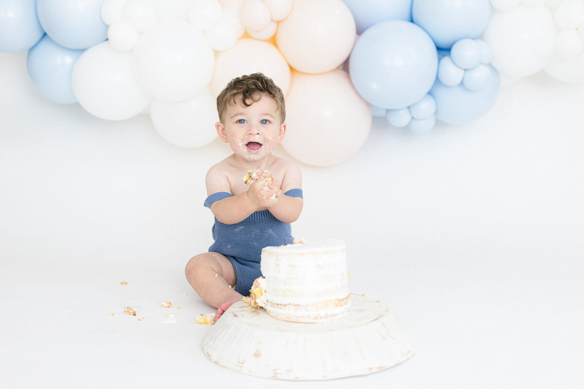 Newborn baby girl sleeping on a white backdrop during her northern kentucky newborn photography session by missy marshall