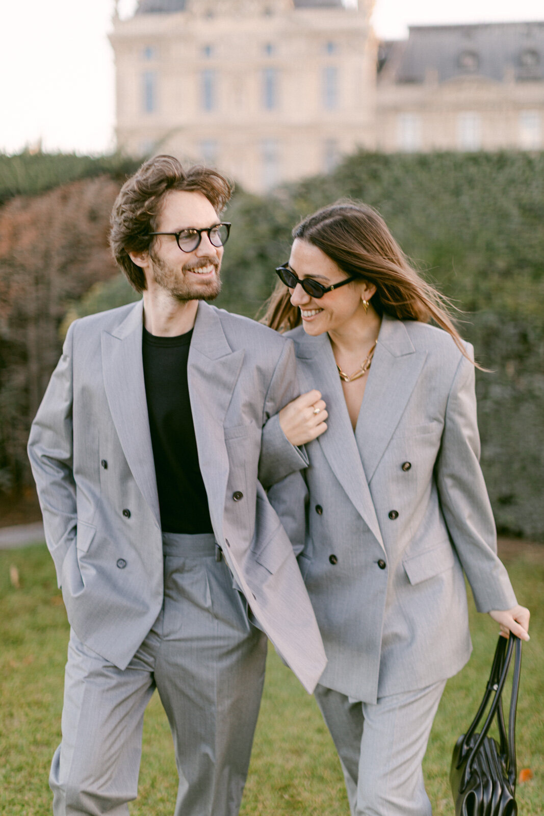 Engagement session at the Tuileries and Louvre in Paris, with a couple walking through the gardens under the morning light.