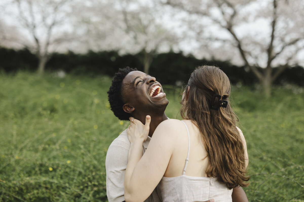 A couple hugging closely and laughing together
