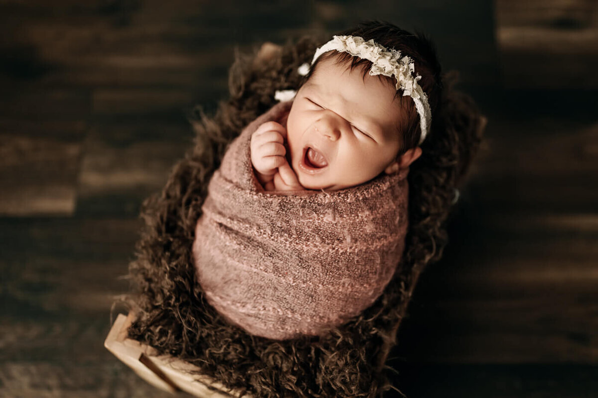 Newborn baby girl yawning