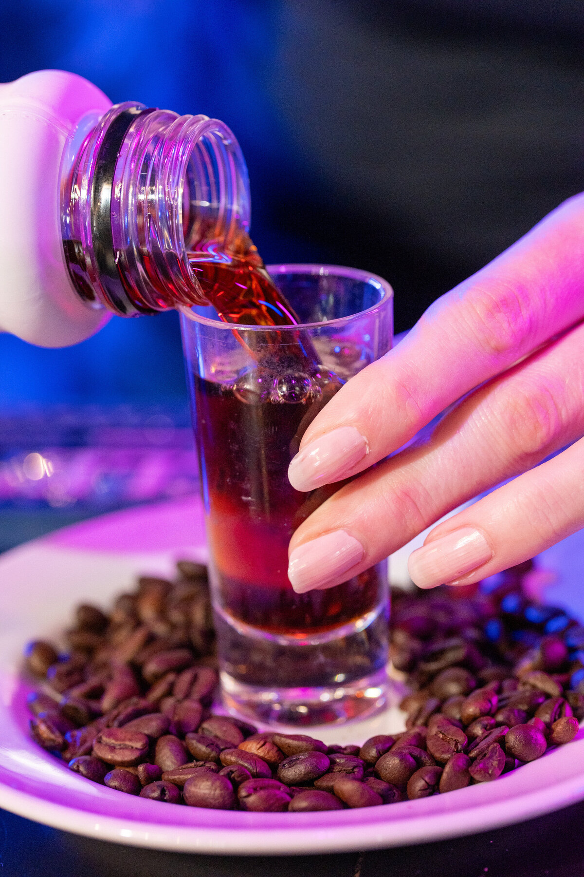 Liquor being poured into a shot glass 