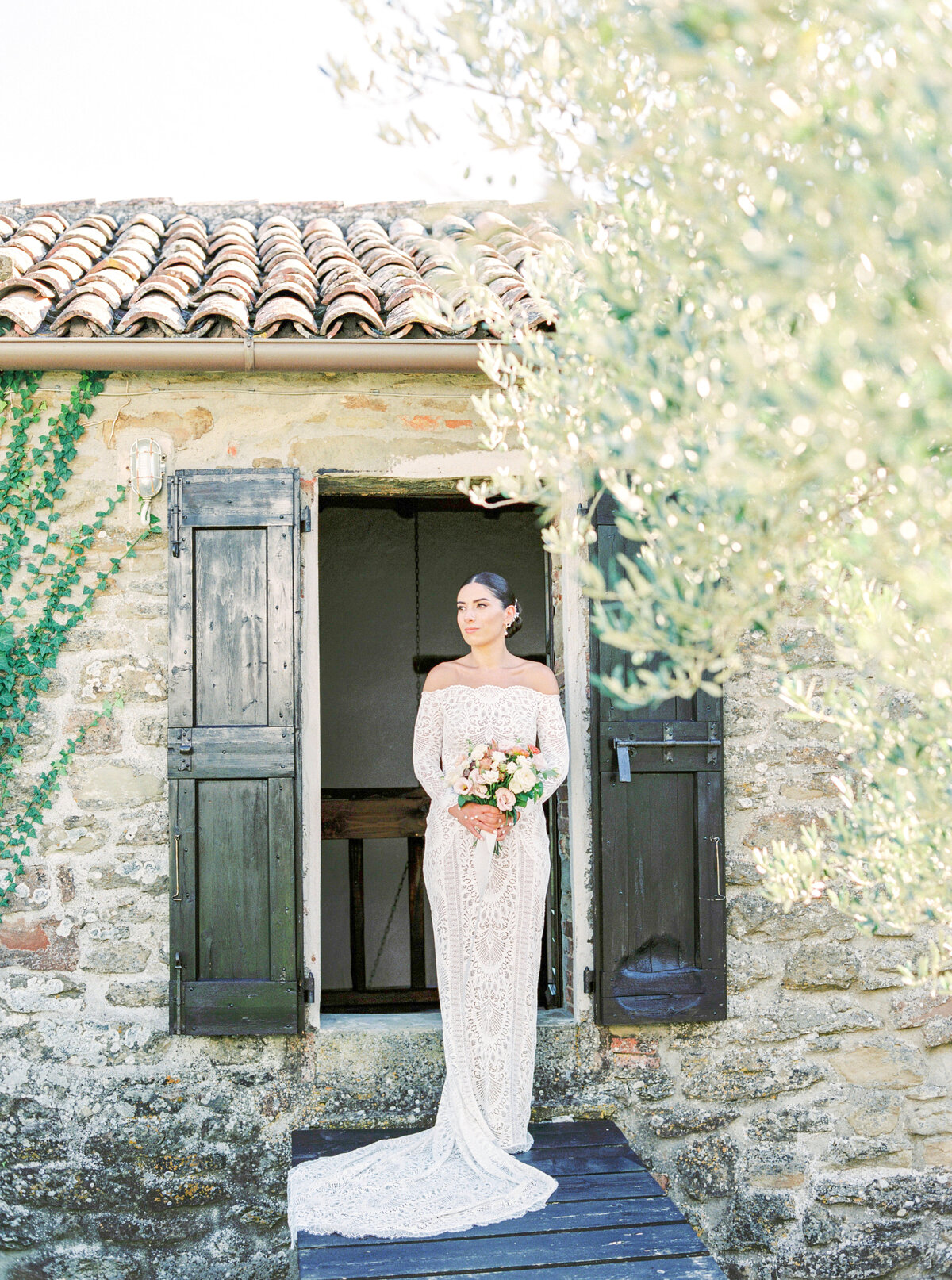Film photograph of bride in all lace wedding dress photographed by Italy wedding photographer at Villa Montanare Tuscany wedding