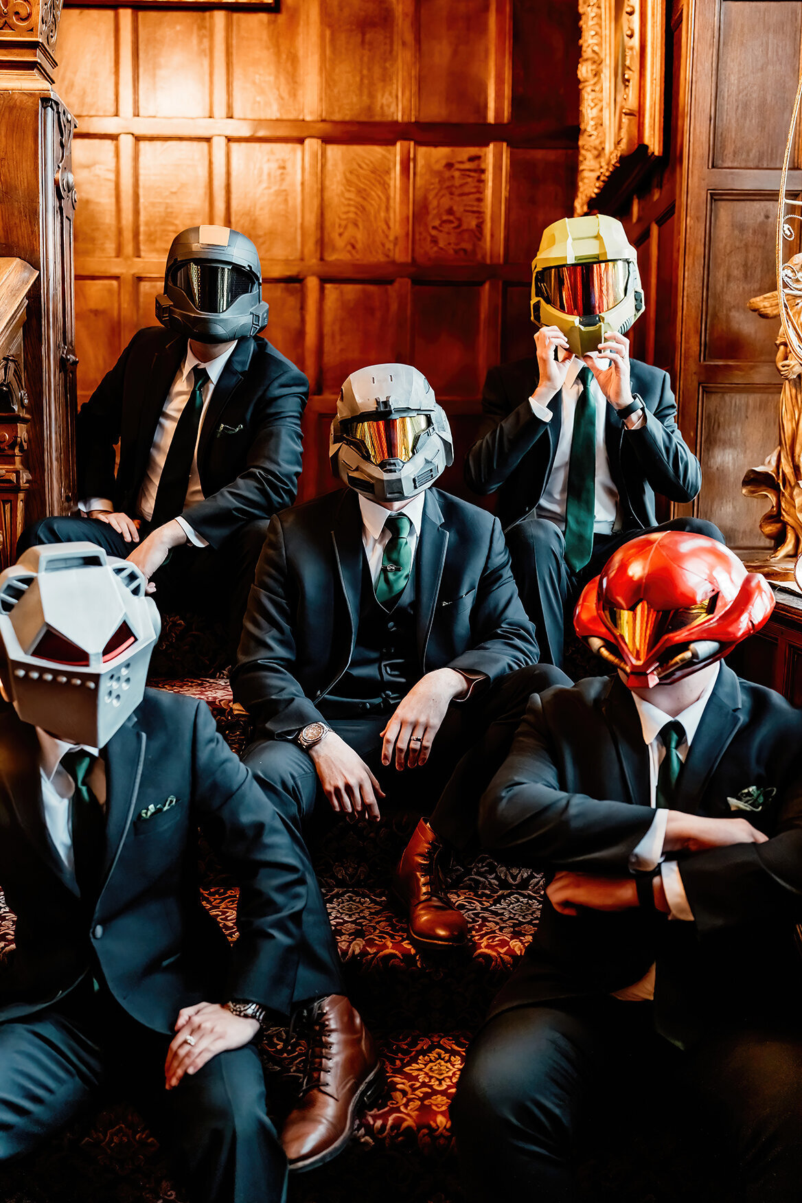 a groom and his groomsmen sitting on stairs of his Tacoma, Wa venue with Halo helmets on