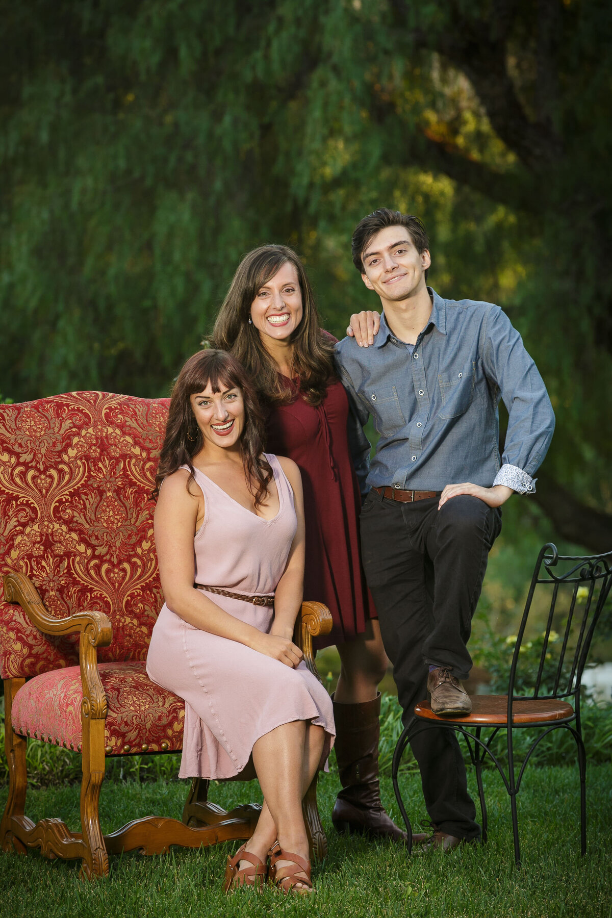 Three grown siblings smiling together