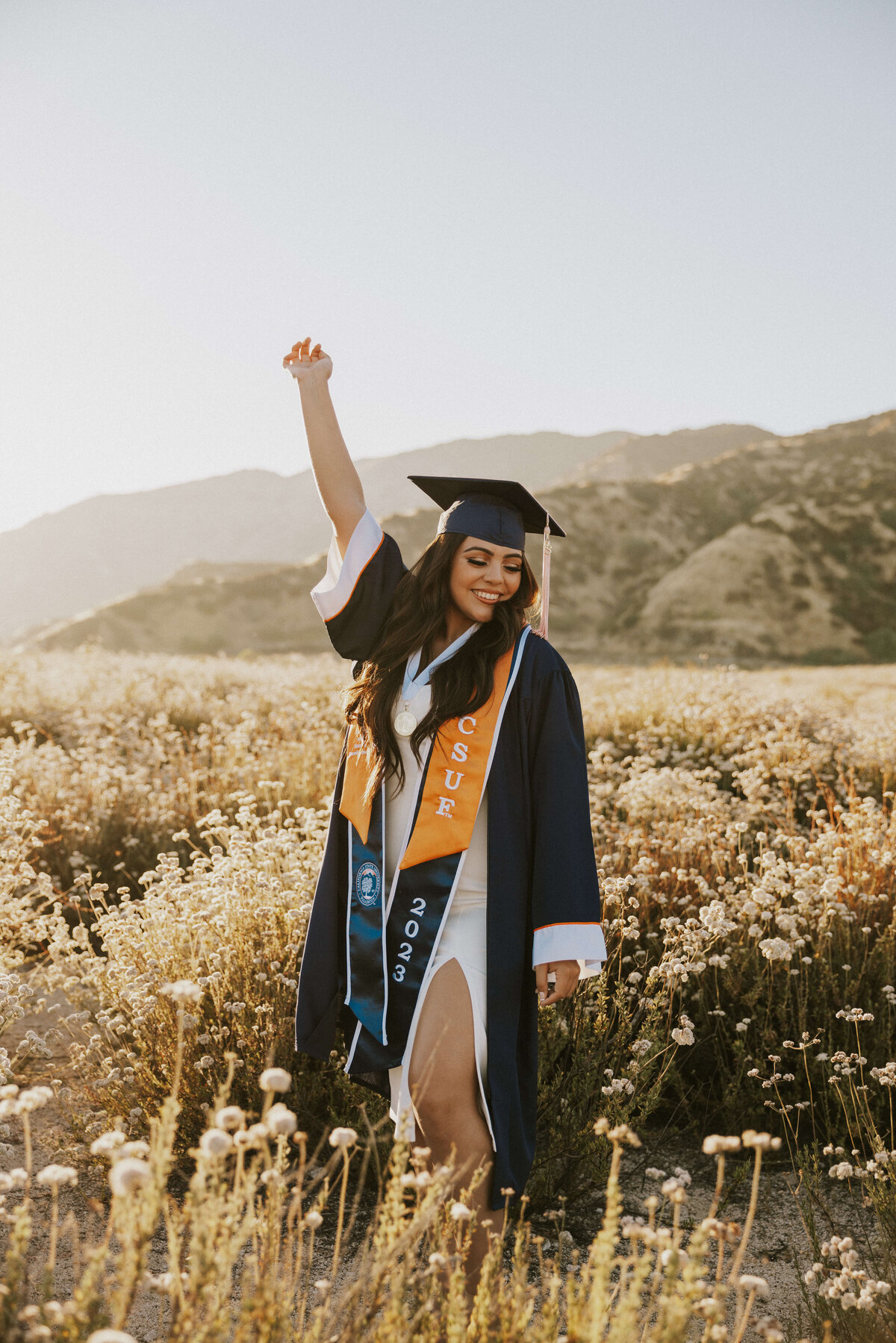 grad-photoshoot-open-field-candid-sash-cap-and-gown