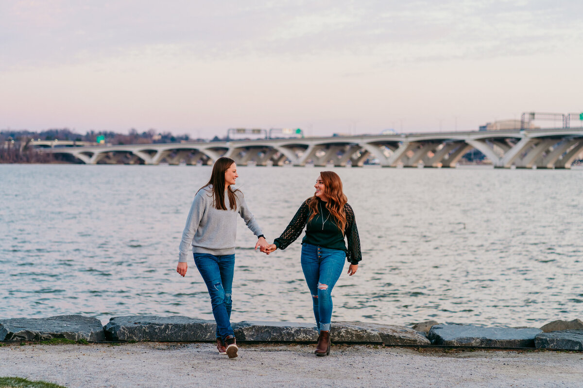 Couple walking hand-in-hand along the waterfront