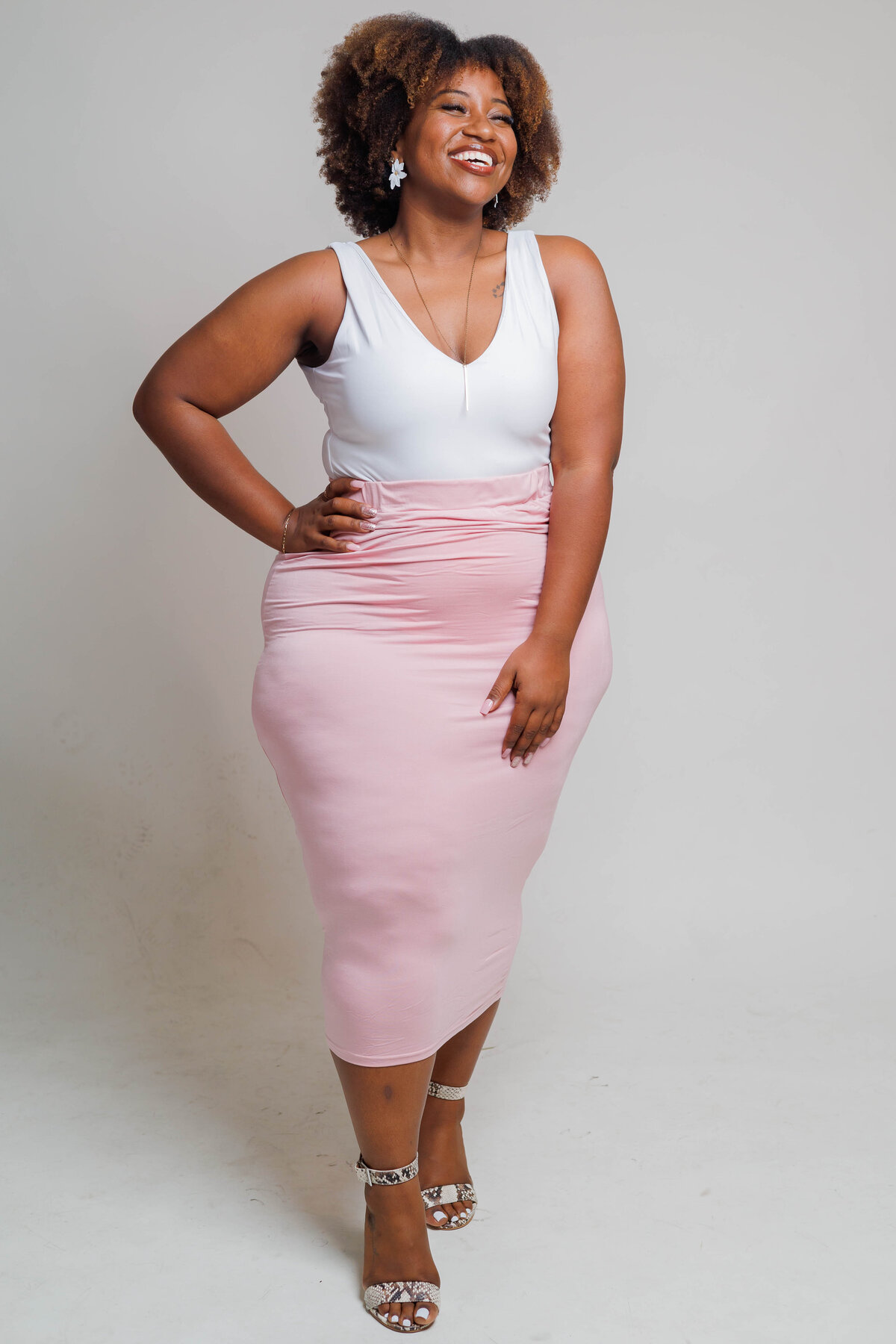 Jazzy, owner of Jazzy's Glam Bar in Tampa, smiling and welcoming clients.