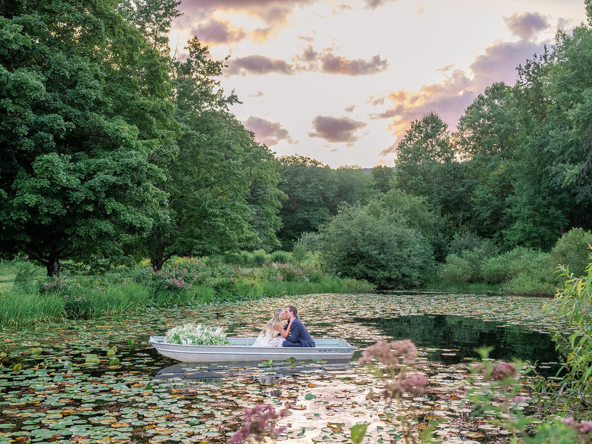 Bride and Groom in Boat with Flowers in Vermont