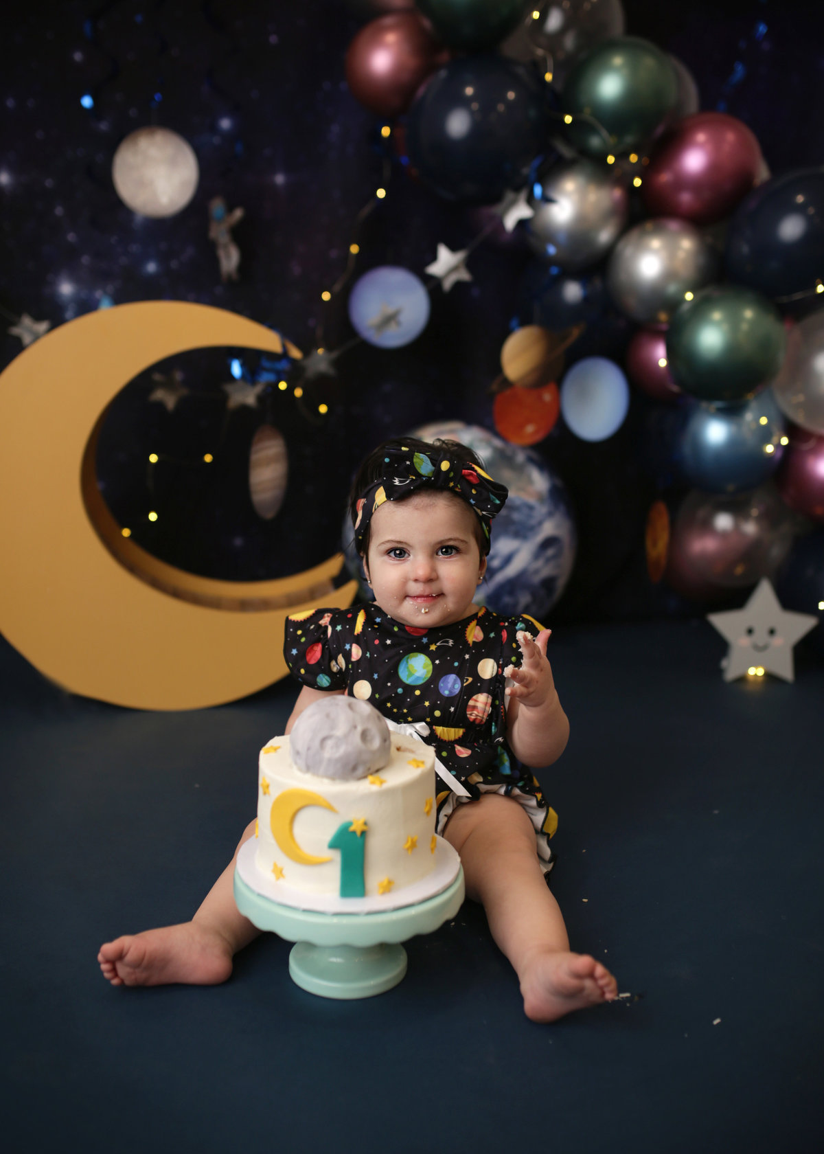 baby girl with astronomical birthday decor