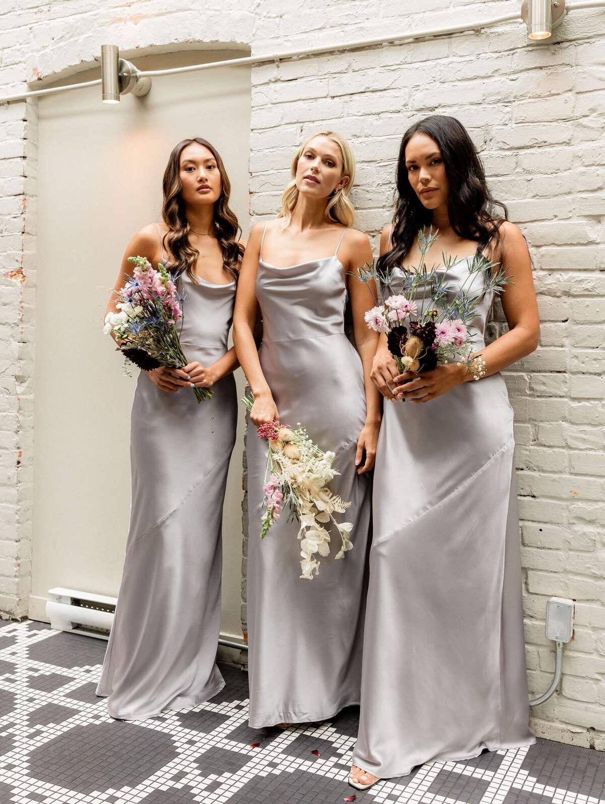 Trendy grey silk bridesmaids dresses from Park & Fifth, a modern bridal boutique based in Calgary, Alberta. Featured on the Brontë Bride Vendor Guide.