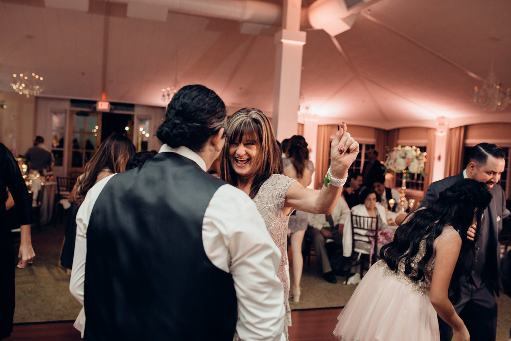 Wedding Photograph Of Woman Dancing With a Man In Gray Vest Los Angeles