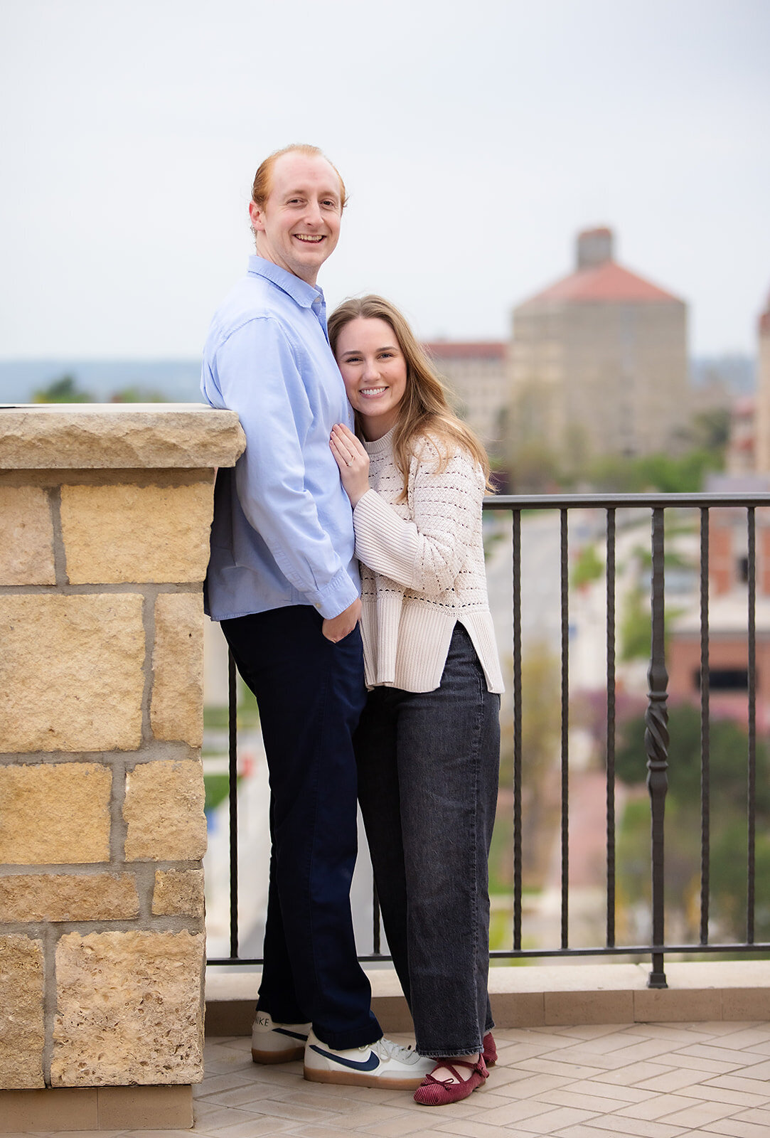 engaged man and woman look at the camera 