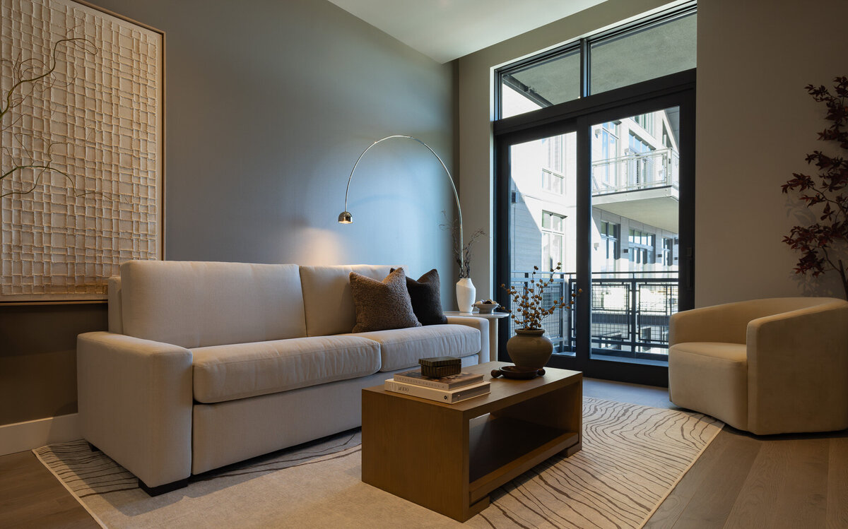 Luxury living room with a white plush couch, accent chair, and wood coffee table styled with decor in a Grand Hyatt Deer Valley condo