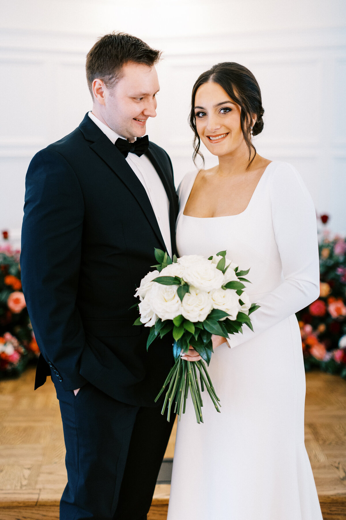 Groom iscouple exchange written vows looking at the bride with happiness
