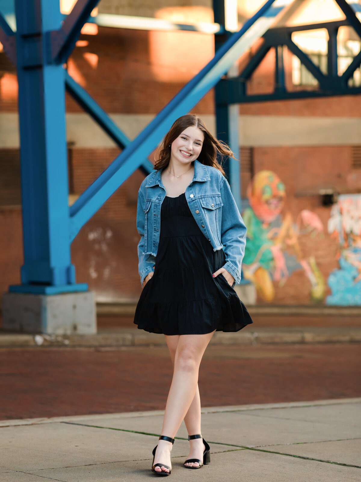 senior girl in jean jacket posed for senior portraits 